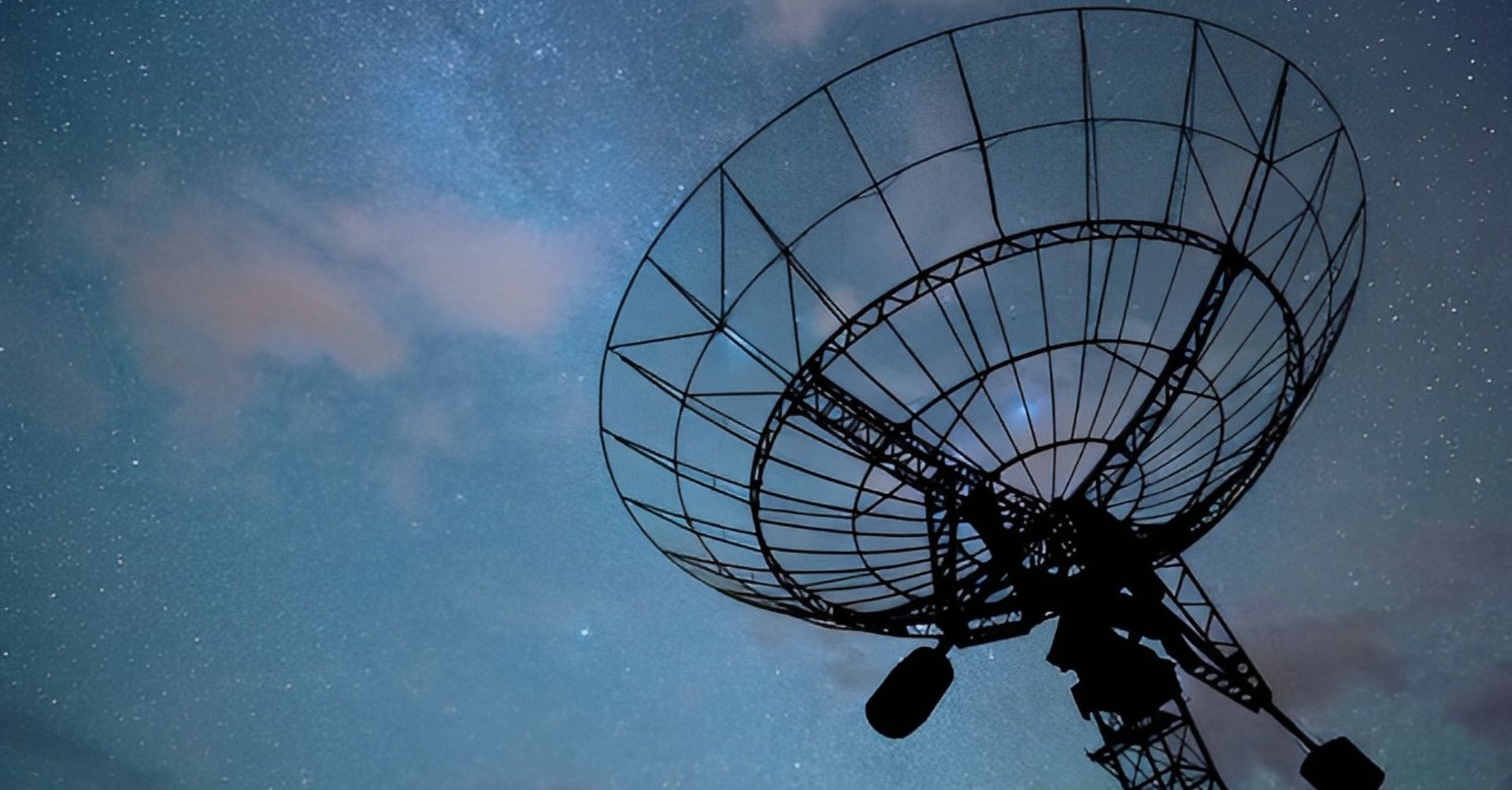 A satellite dish is shown against the sky.